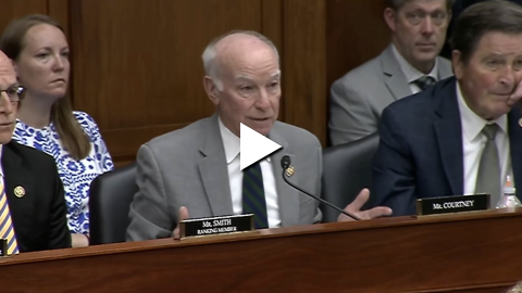 An image of Rep. Joe Courtney speaking in a House Armed Services Committee hearing with a "play" button overlayed.