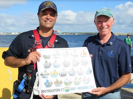 Rep. Courtney presenting Commander Brian Tanaka of the USS Minnesota with a Connecticut Submarine Century print on Monday 